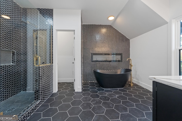 bathroom featuring lofted ceiling, tile patterned flooring, and separate shower and tub