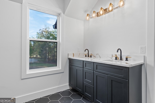 bathroom with tile patterned flooring, a healthy amount of sunlight, and vanity