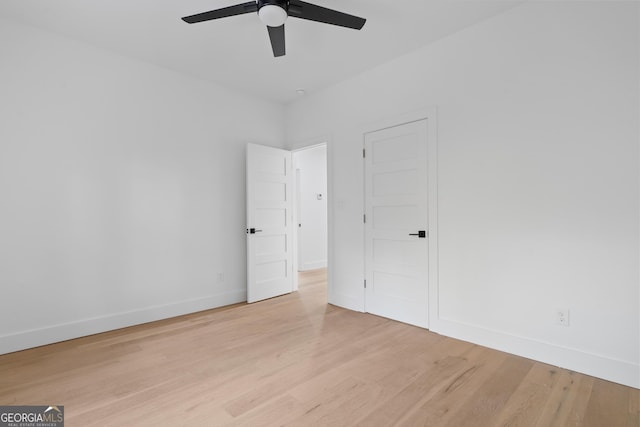 unfurnished bedroom with ceiling fan and light wood-type flooring