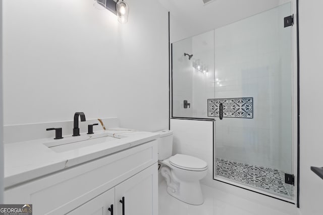 bathroom featuring a shower with shower door, tile patterned floors, toilet, and vanity