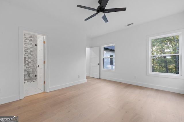 empty room with ceiling fan and light wood-type flooring