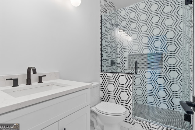 bathroom featuring an enclosed shower, vanity, and toilet