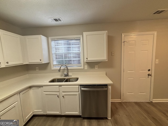 kitchen with white cabinets, a textured ceiling, dark hardwood / wood-style floors, sink, and stainless steel dishwasher