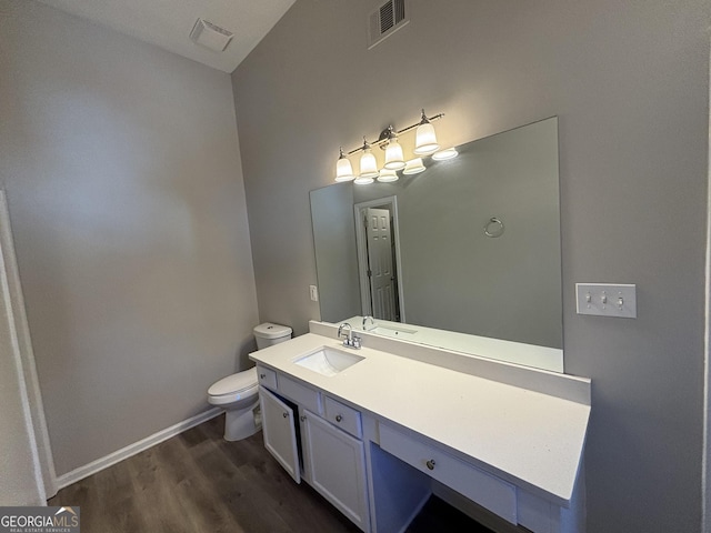 bathroom featuring toilet, hardwood / wood-style flooring, and vanity