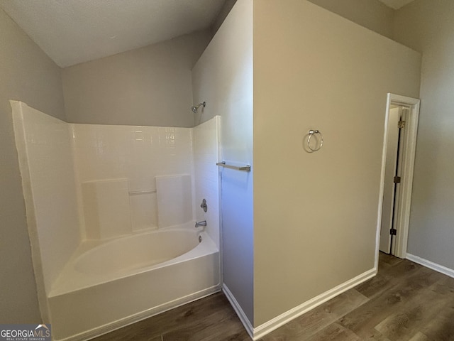 bathroom with hardwood / wood-style floors and  shower combination