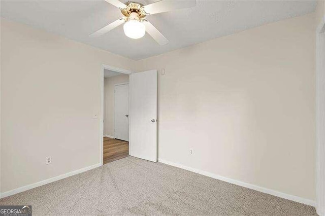 unfurnished room featuring ceiling fan and carpet floors