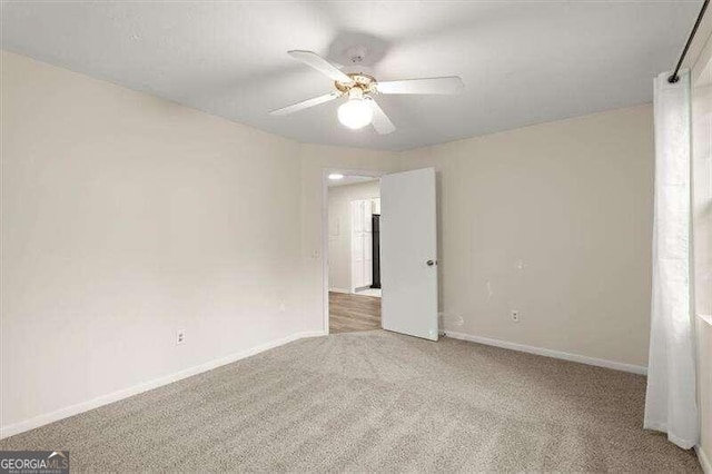 carpeted empty room with ceiling fan