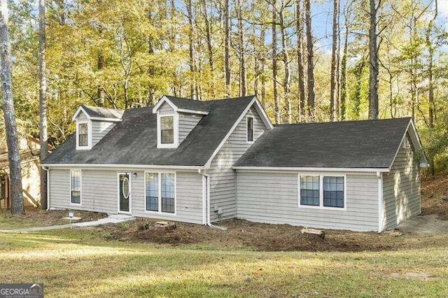 new england style home featuring a front yard