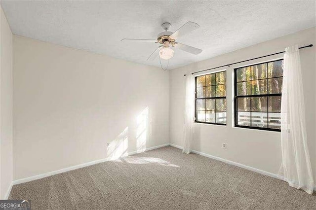 carpeted empty room with a textured ceiling and ceiling fan