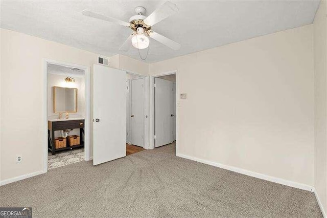 unfurnished bedroom featuring carpet and ceiling fan