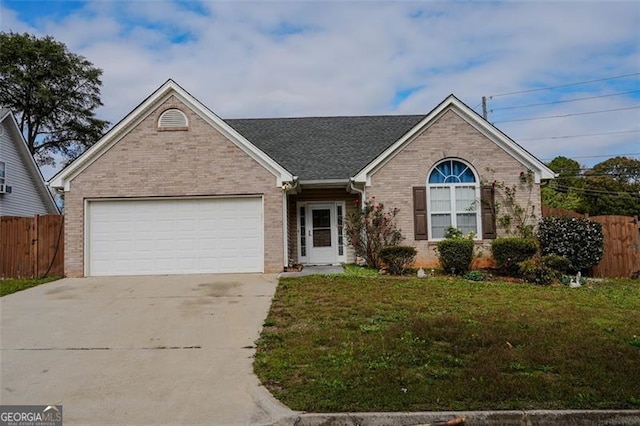 view of front of home featuring a front lawn and a garage