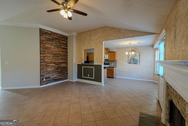 unfurnished living room with lofted ceiling, ceiling fan with notable chandelier, light tile patterned floors, a textured ceiling, and ornamental molding