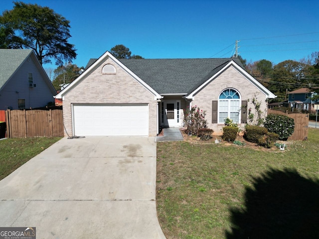 view of front of home featuring a front yard and a garage