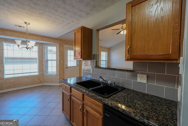 kitchen with ceiling fan with notable chandelier, light tile patterned floors, a textured ceiling, and sink