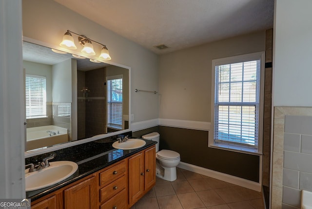 bathroom featuring vanity, a textured ceiling, tile patterned floors, and toilet