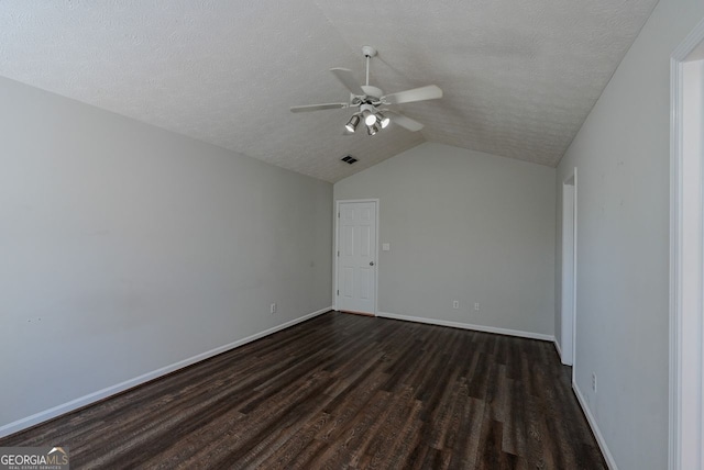 additional living space featuring a textured ceiling, vaulted ceiling, ceiling fan, and dark wood-type flooring