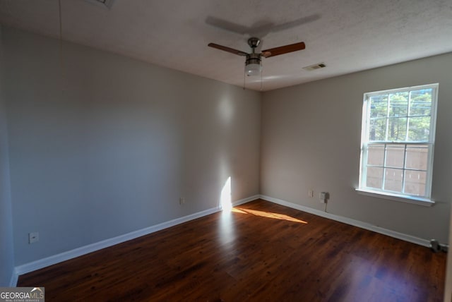 spare room with ceiling fan and dark hardwood / wood-style floors