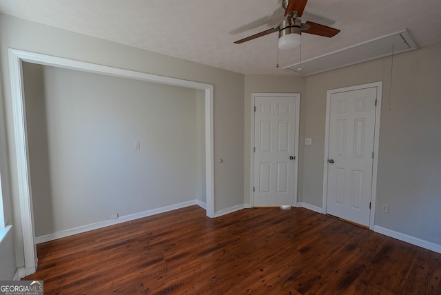 unfurnished bedroom with ceiling fan, dark hardwood / wood-style flooring, and a textured ceiling