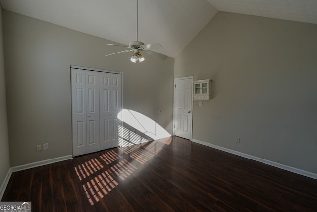 spare room with high vaulted ceiling, ceiling fan, and dark wood-type flooring