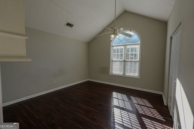 spare room featuring ceiling fan, dark hardwood / wood-style flooring, and lofted ceiling