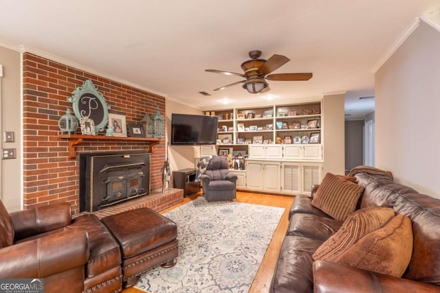 living room with ceiling fan, light hardwood / wood-style flooring, built in features, and ornamental molding