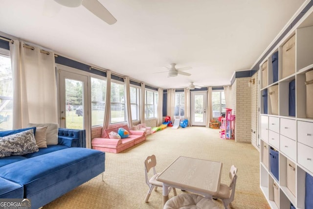 sunroom featuring plenty of natural light and ceiling fan