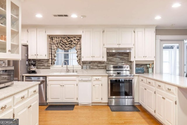 kitchen featuring a healthy amount of sunlight, sink, white cabinets, and stainless steel appliances