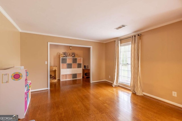 interior space featuring wood-type flooring and ornamental molding