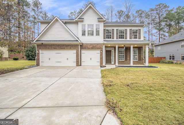 view of front of house featuring a porch, a garage, and a front yard