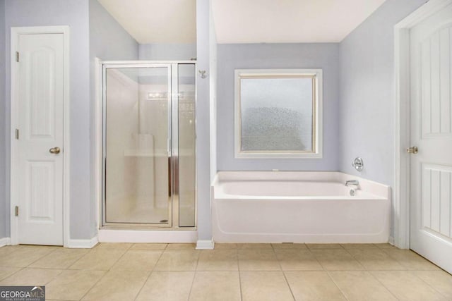 bathroom with tile patterned floors and plus walk in shower