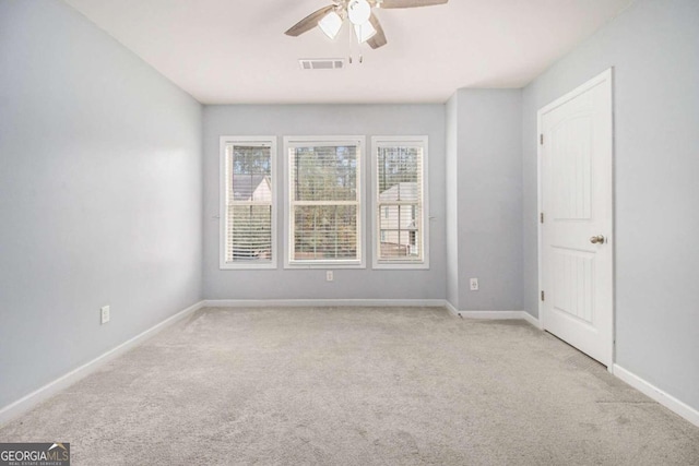 spare room featuring ceiling fan and light colored carpet