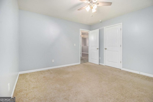 empty room with ceiling fan and carpet