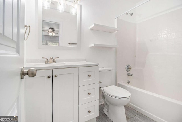 full bathroom featuring ceiling fan, toilet, washtub / shower combination, and vanity