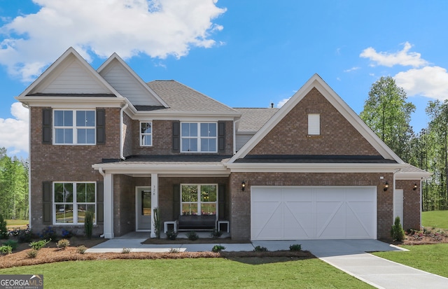 craftsman inspired home featuring a porch, a garage, and a front lawn