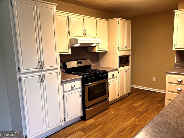 kitchen with white cabinetry, dark hardwood / wood-style floors, stainless steel gas range, and built in microwave