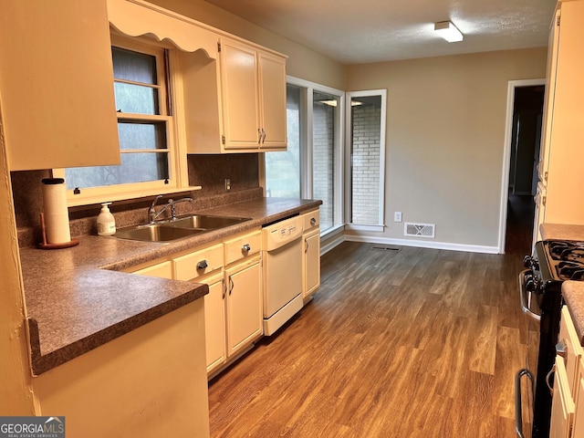 kitchen featuring dark hardwood / wood-style flooring, sink, white dishwasher, tasteful backsplash, and range with gas cooktop