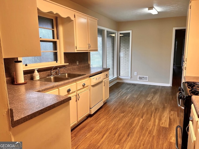 kitchen featuring decorative backsplash, hardwood / wood-style flooring, a textured ceiling, and appliances with stainless steel finishes