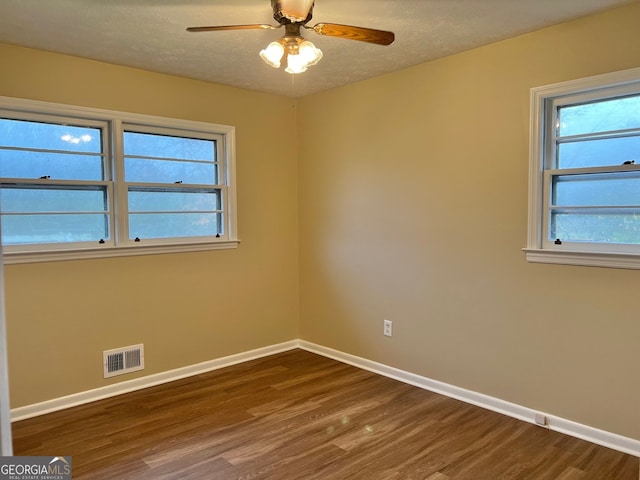 empty room featuring hardwood / wood-style flooring, ceiling fan, and a textured ceiling