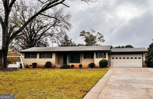 single story home featuring a front yard and a garage