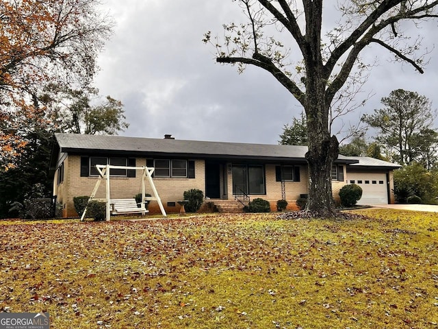 single story home featuring a front yard and a garage