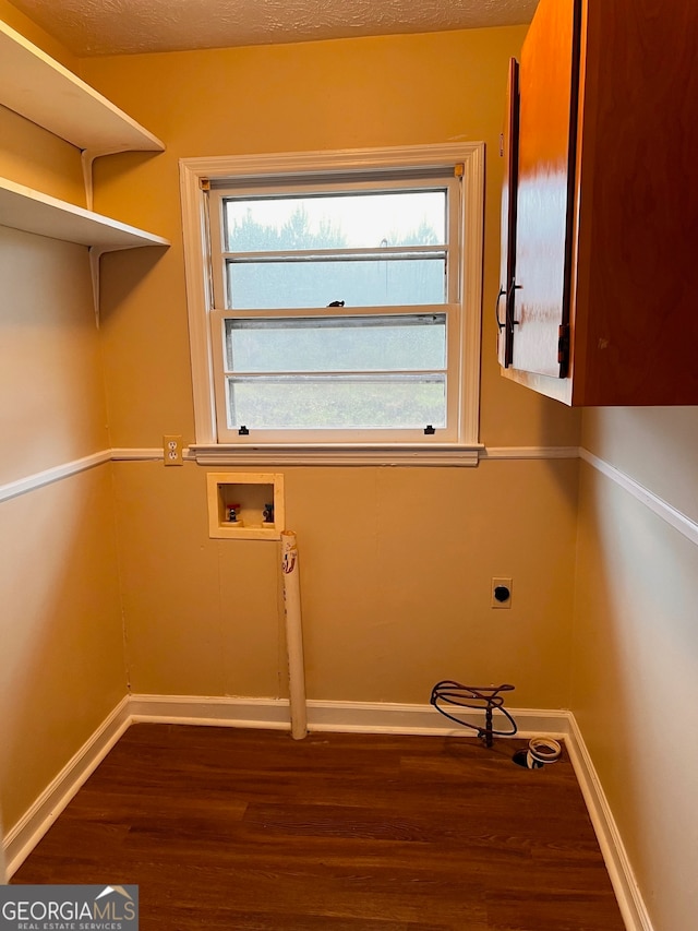 laundry area with washer hookup, electric dryer hookup, dark wood-type flooring, and cabinets