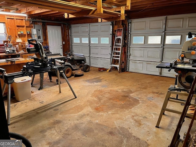 garage featuring wood walls and a workshop area