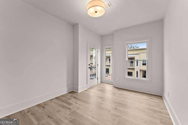 spare room featuring light hardwood / wood-style floors