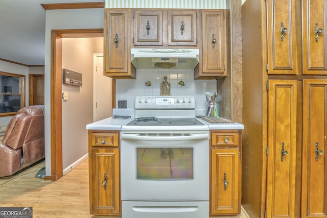 kitchen featuring light wood-type flooring, tasteful backsplash, white range with electric stovetop, and crown molding