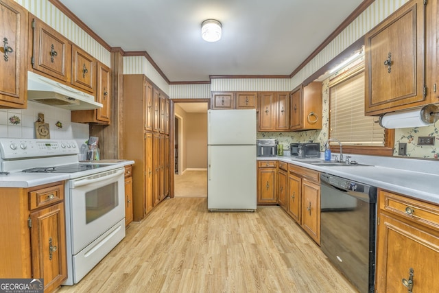 kitchen with sink, light hardwood / wood-style flooring, white appliances, decorative backsplash, and ornamental molding