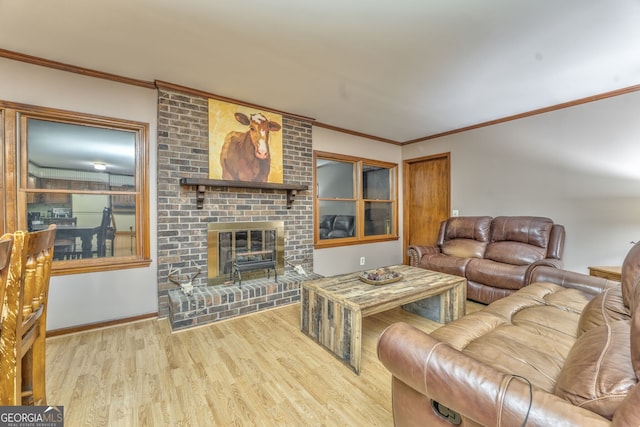 living room with crown molding, light hardwood / wood-style floors, and a brick fireplace