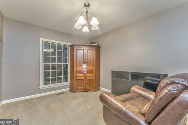 sitting room with a chandelier and light colored carpet