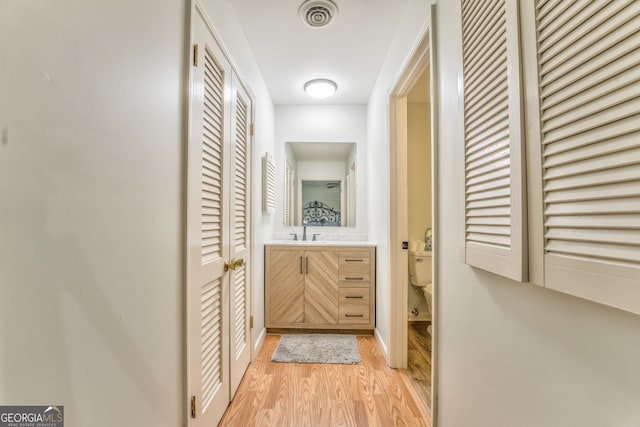 hallway featuring light hardwood / wood-style flooring and sink