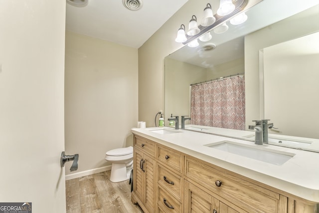 bathroom with vanity, wood-type flooring, and toilet