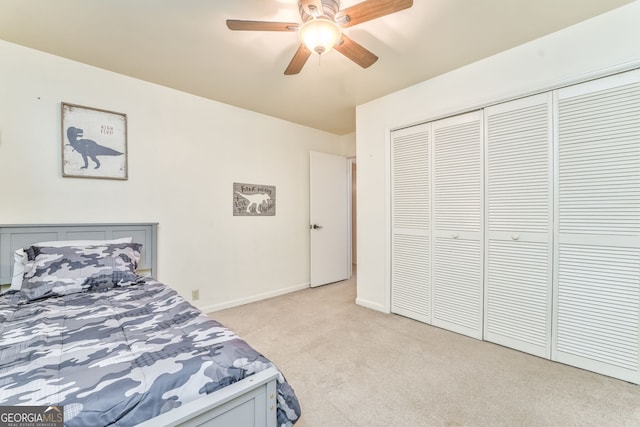 carpeted bedroom featuring ceiling fan and a closet